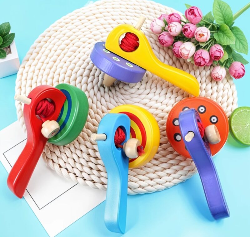 Wooden spinning top with string